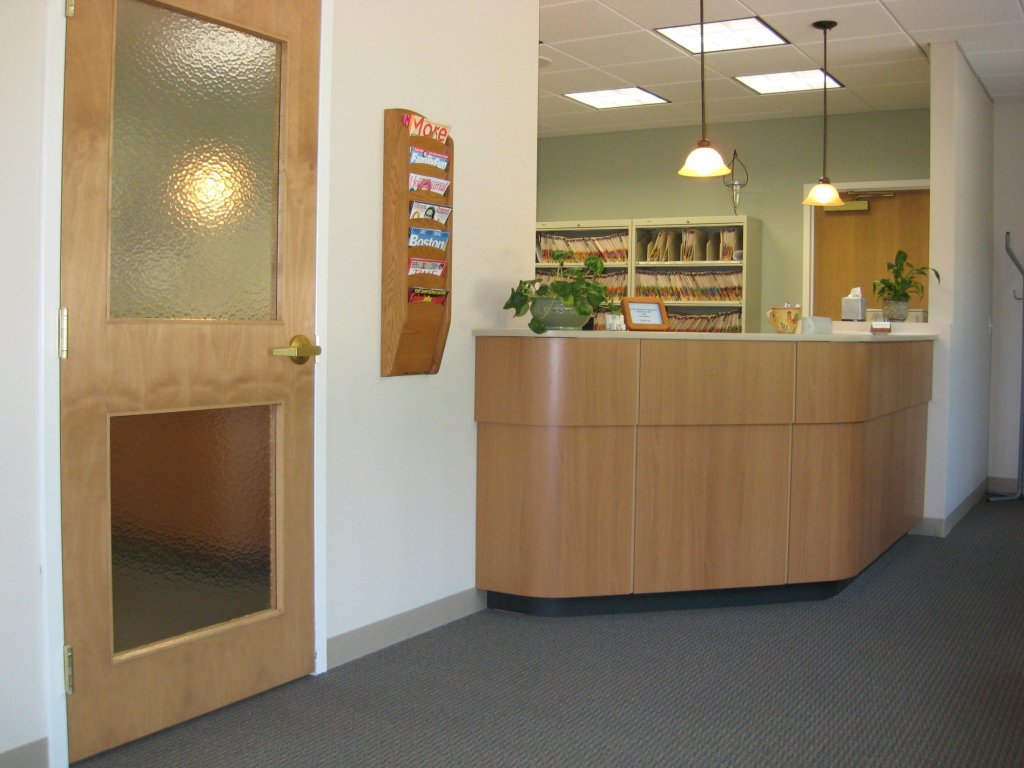 Dental office reception area with front desk and patient check-in counter