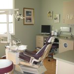 Modern dental treatment room equipped with advanced dental technology and patient chair